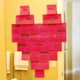 100 Things I Love about You Sticky Notes in the shape of a heart on a mirror