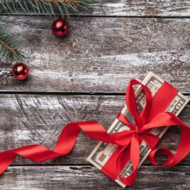 Money for Christmas tied in red bow | Date Your Spouse