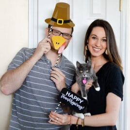 Couple using Thanksgiving photo booth props | Date Your Spouse