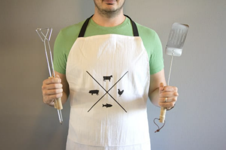 A man enjoying cooking with his manly apron - dateyourspouse.com A man trying out his Man Apron this Christmas | The Dating Divas