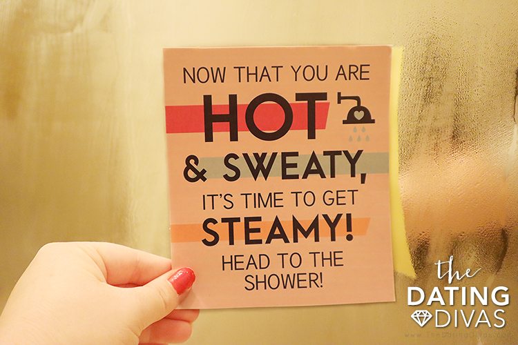 A woman using the Sexercise printable to have a sexy shower date with her husband - dateyourspouse.com Wife holding Sexercise printable in the steamy shower | The Dating Divas
