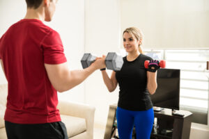 A couple working out together using weights - dateyourspouse.com A husband and wife doing bicep curls at home | The Dating Divas
