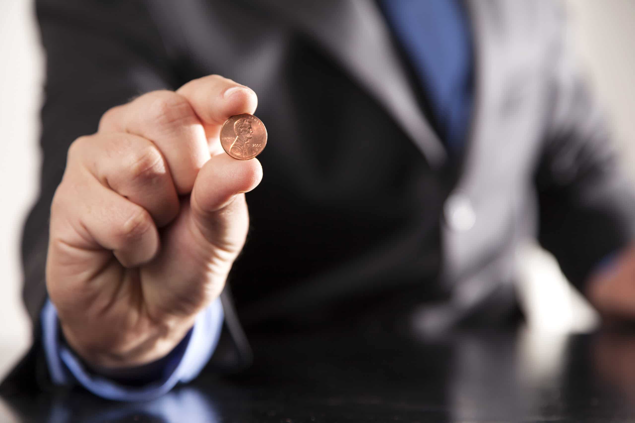 A penny to be used during Minute to Win It challenge - dateyourspouse.com A hand holding a penny to be used during Minute to Win It game | The Dating Divas