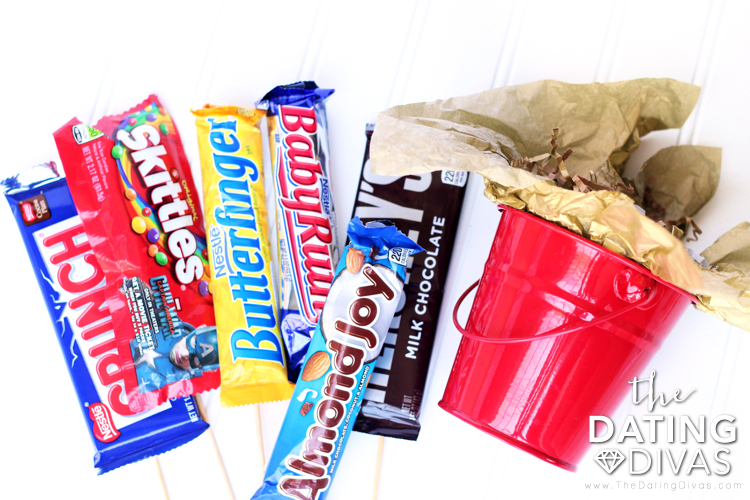 Candy and Red Bucket for Candy Bouquet - dateyourspouse.com Red bucket and candy bars to build a DIY candy bouquet for that special someone. | The Dating Divas