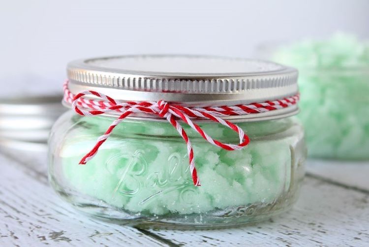 Mint sugar scrub inside a small glass jar that is wrapped with red and white twine gift idea - dateyourspouse.com Homemade mint sugar scrub in a small glass jar tied with baker's twine | The Dating Divas
