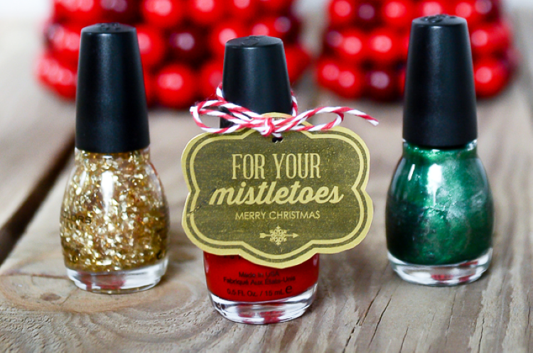 Different colored bottles of nail polish and a Christmas tag - dateyourspouse.com Nail polish bottles tied with a Christmas gift tag | The Dating Divas