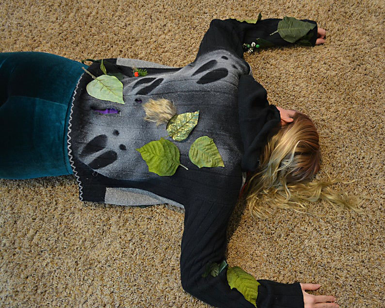 Reindeer tracks across an ugly Christmas sweater - www.TheDatingDivas.com Woman Lays Down with Reindeer Tracks on Her Back for an Ugly Sweater Party | The Dating Divas