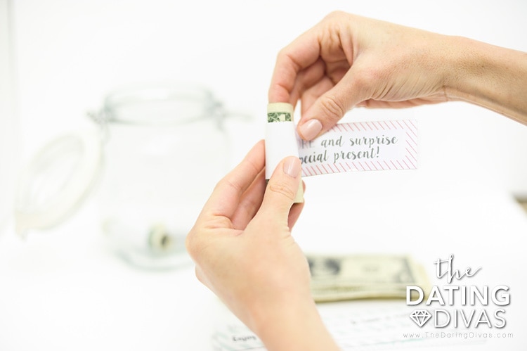 A couple enjoying their Date Night Money in a Jar this Christmas - dateyourspouse.com Girlfriend gifting the Date Night Money Jar to boyfriend | The Dating Divas