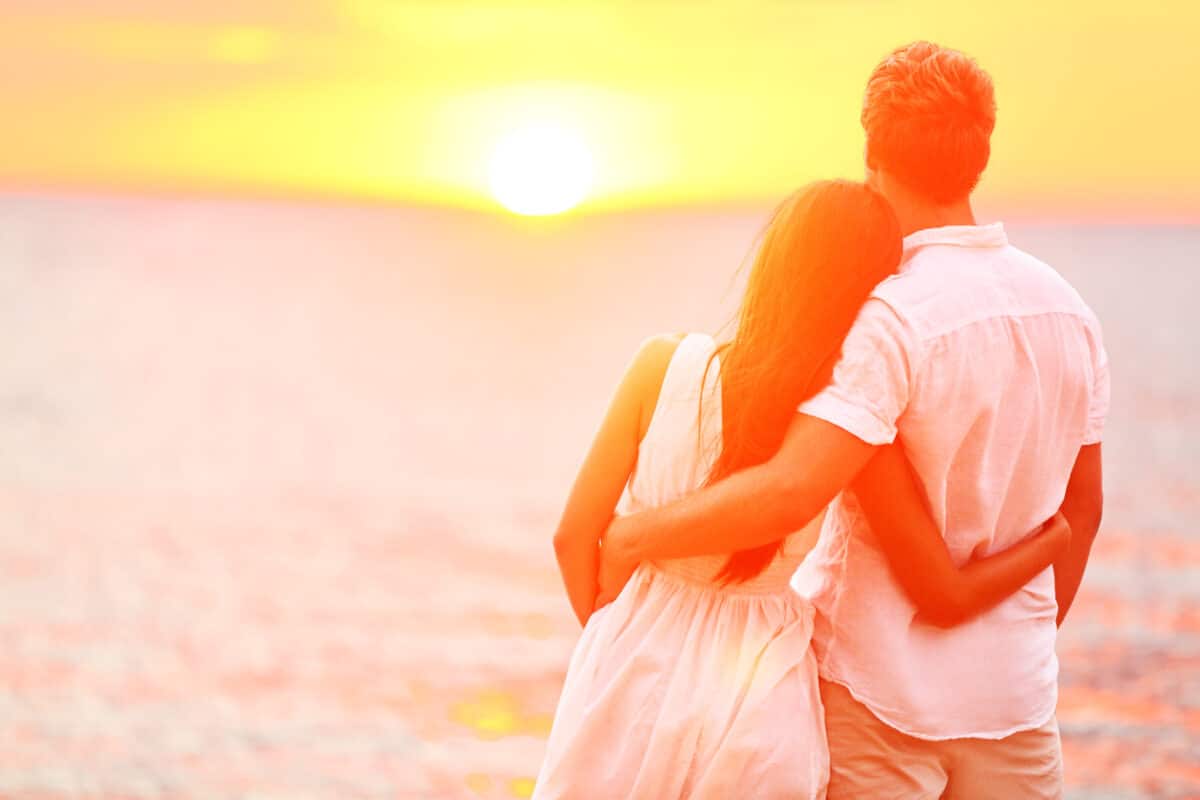 Couple in love gazing at sunset | The Dating Divas