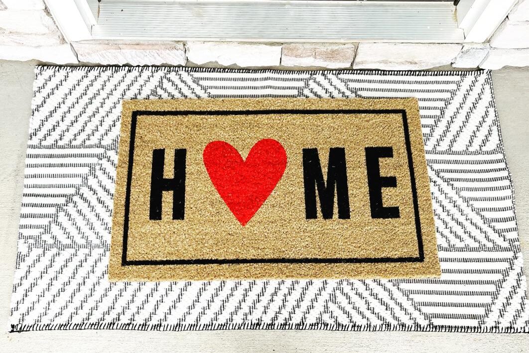 An adorable doormat is the perfect way to decorate for Valentine's. | The Dating Divas