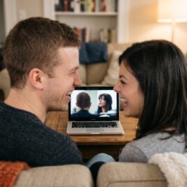 couple laughing at a funny marriage video