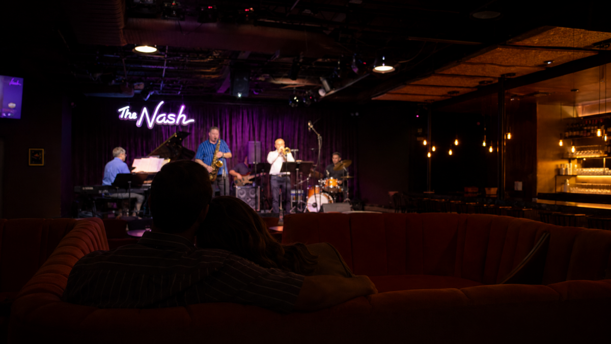Couple cuddled up listening to musicians at a jazz club