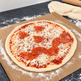 Homemade jack-o'-lantern pizza with a pepperoni face for a Halloween date night