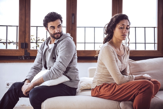 Husband looking over his shoulder at his wife upset